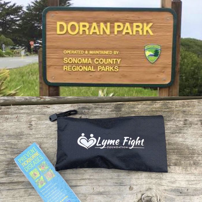 LymeFight foundation tick kit pouch in front of Doran Park Sonoma
